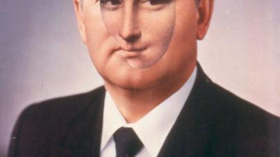 Photograph of Gorbachev in a suit with a Soviet pin, featuring a superimposed oval cutout of the Mona Lisa's face centered over his face. 