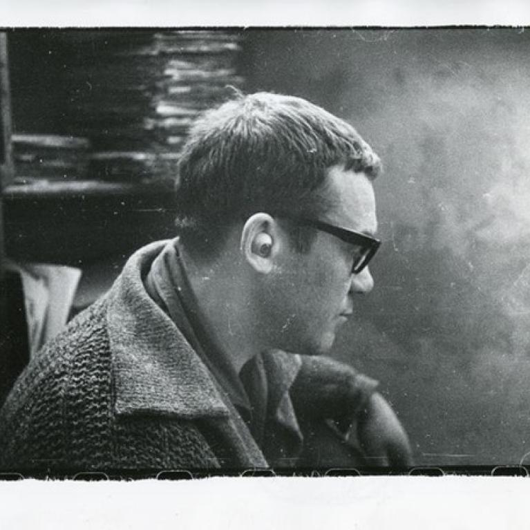 short-haired man in glasses facing off the camera