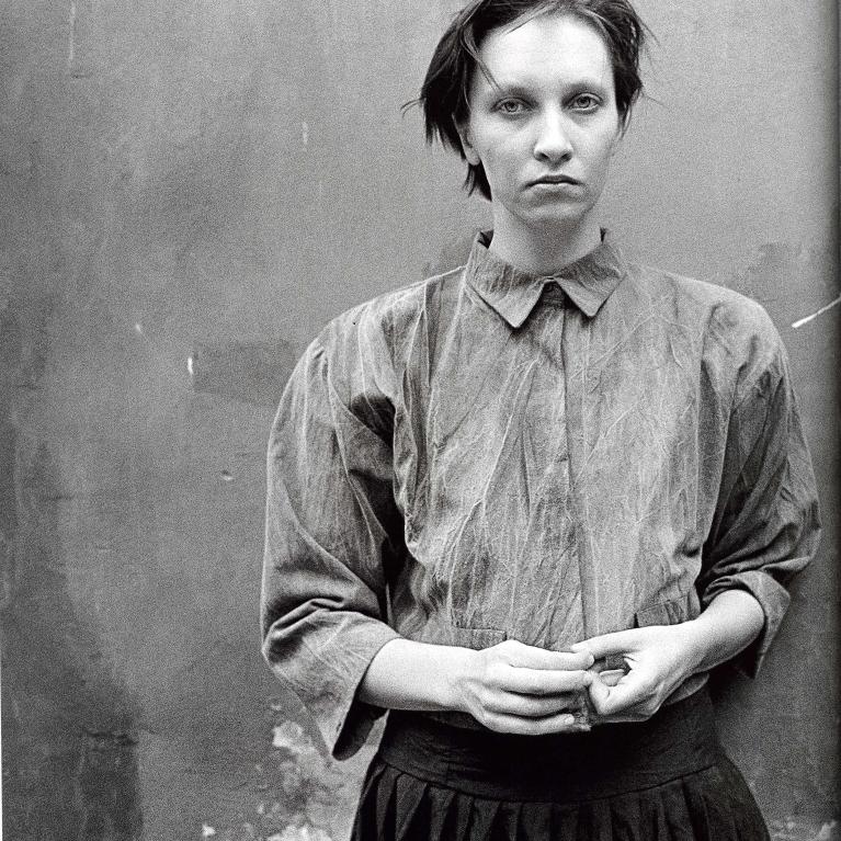 young woman with short hair in buttoned up shirt 