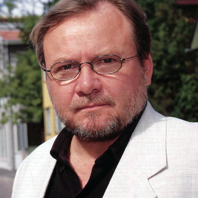 white blonde middle-aged man wearing glasses and beard