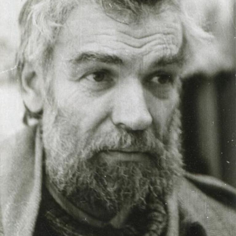 headshot of a bearded man in sweater