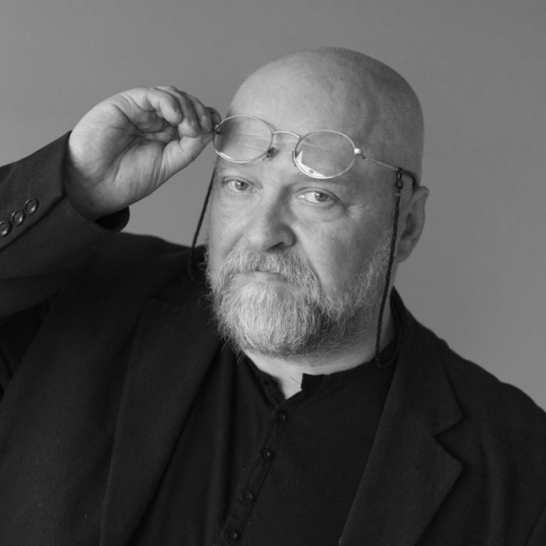 middle-aged bald man wearing glasses and beard 