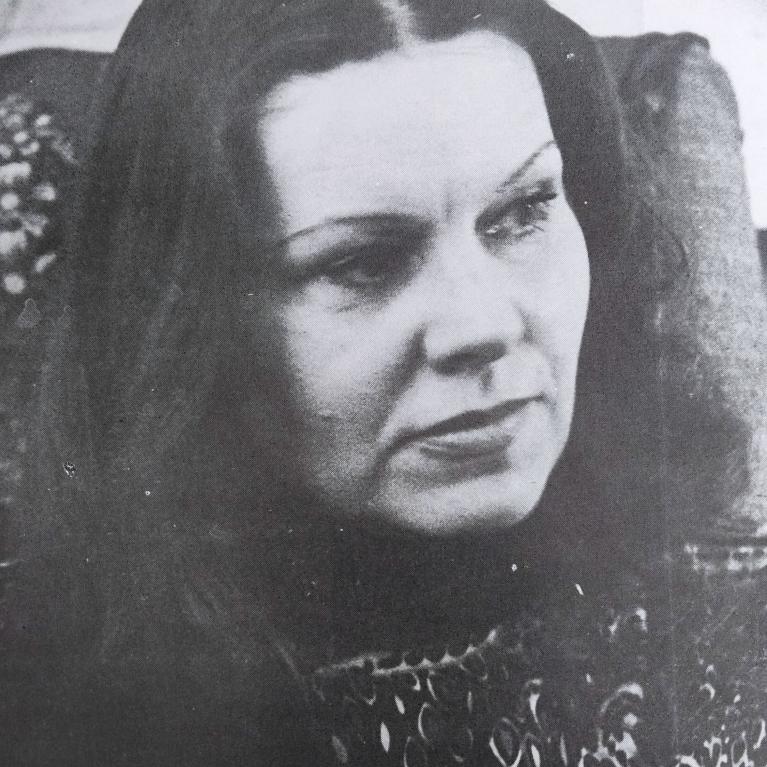 old photo of a middle-aged woman with long straight hair 