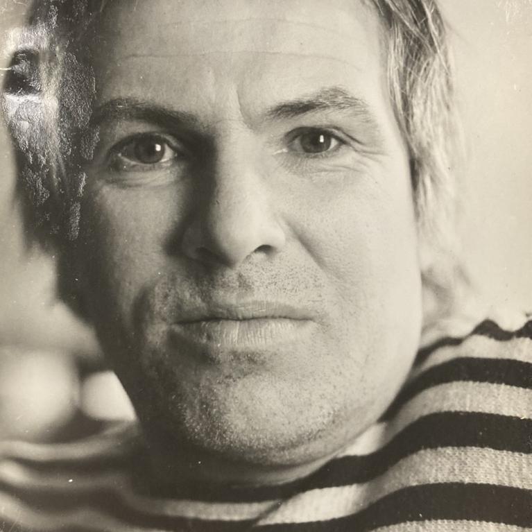 Black and white photograph of a person wearing a striped shirt